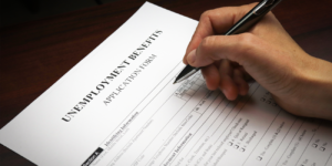 Former employee fills out unemployment benefits application for compensation.